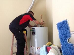 Plumber performing water heater repair in Fort Myers, FL at a residential home
